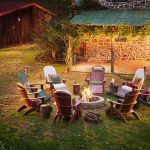 Adirondack chairs around a campfire