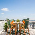 Green and cedar Amish made poly outdoor dining set with 4 chairs on deck.