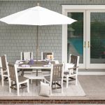 2-tone poly outdoor dining table and 6 chairs on hardscape patio.