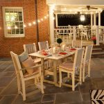 Amish crafted poly outdoor dining furniture on flagstone patio at night.