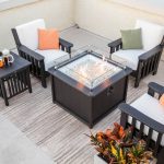 Black poly deep seating patio furniture, end table and fire pit on roof top balcony