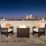 Amish crafted poly outdoor furniture - black poly deep seating chairs and fire pit on balcony