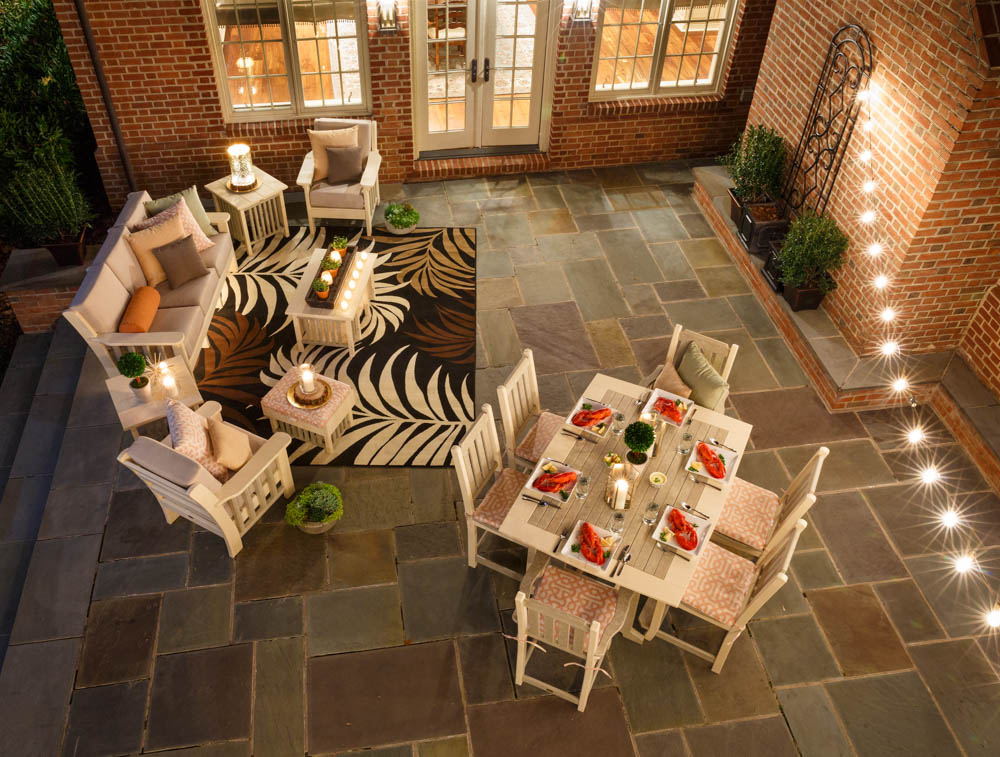 Poly dining and patio furniture by Finch on patio at dusk