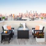 Black Amish crafted poly patio deep seating furniture with fire pit on rooftop balcony