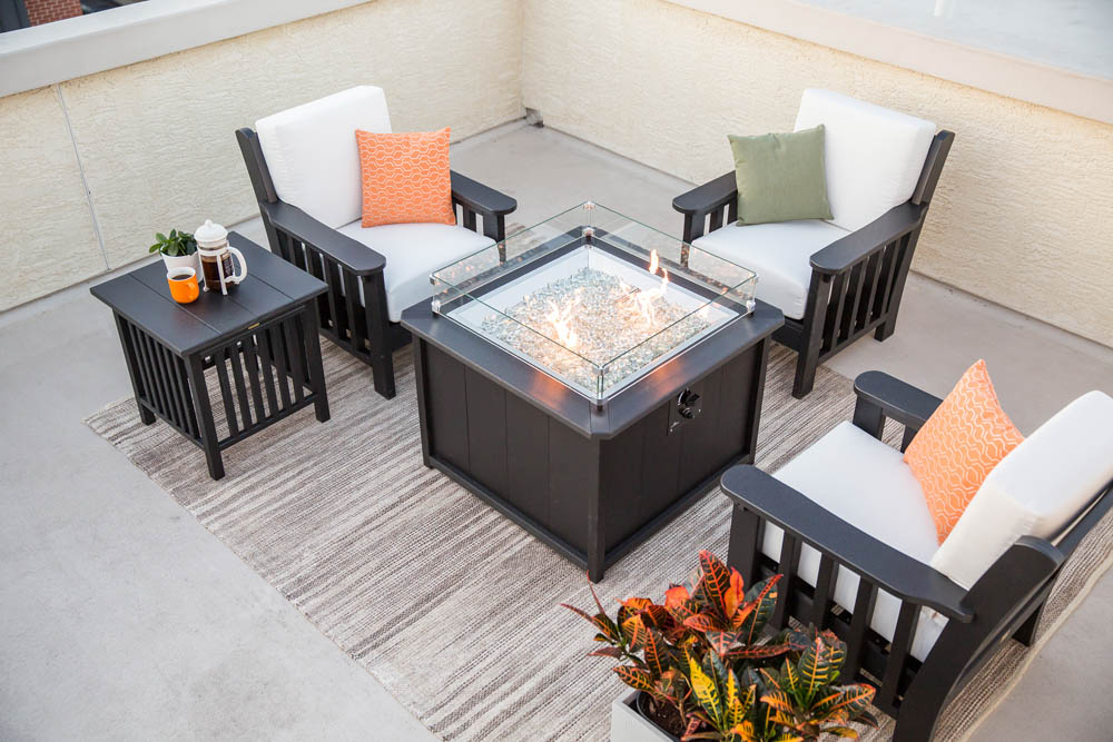 Outdoor patio furniture around a gas fire pit