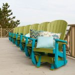 Lime green and Aruba blue poly glider rockers lined up on porch.