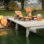 2 cedar and brown chaise lounge chairs on dock.