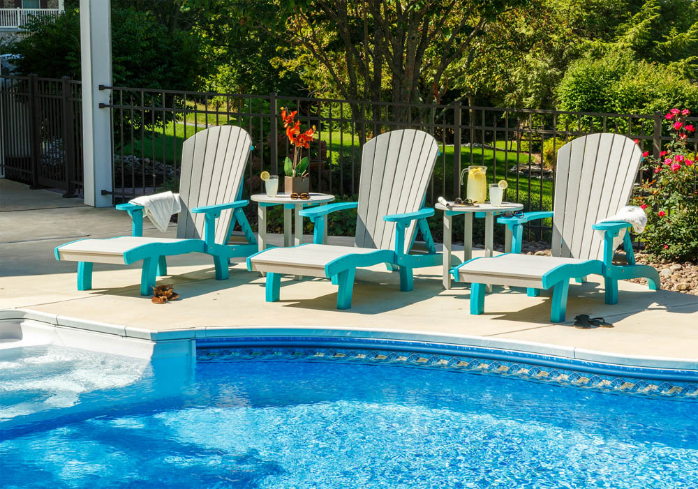 Three Poly lounge chairs by a pool