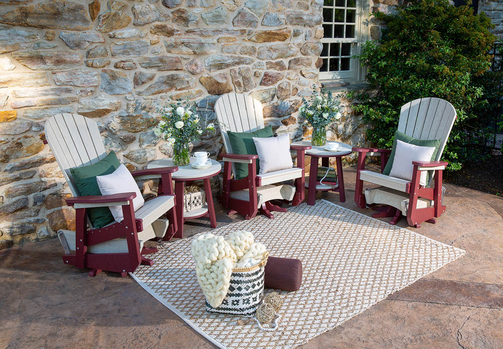 poly chairs on patio with stone home background