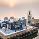 Amish crafted poly outdoor dining furniture on a dock at sunset