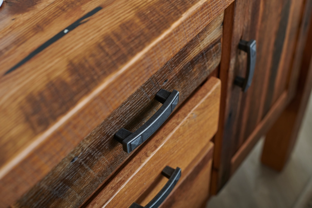 close up picture of drawer pulls and stained wood drawers