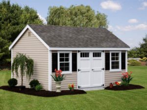 Vinyl Cape Cod style storage shed on manicured lawn.