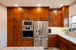 custom kitchen cabinets with built in stove, microwave and fridge.