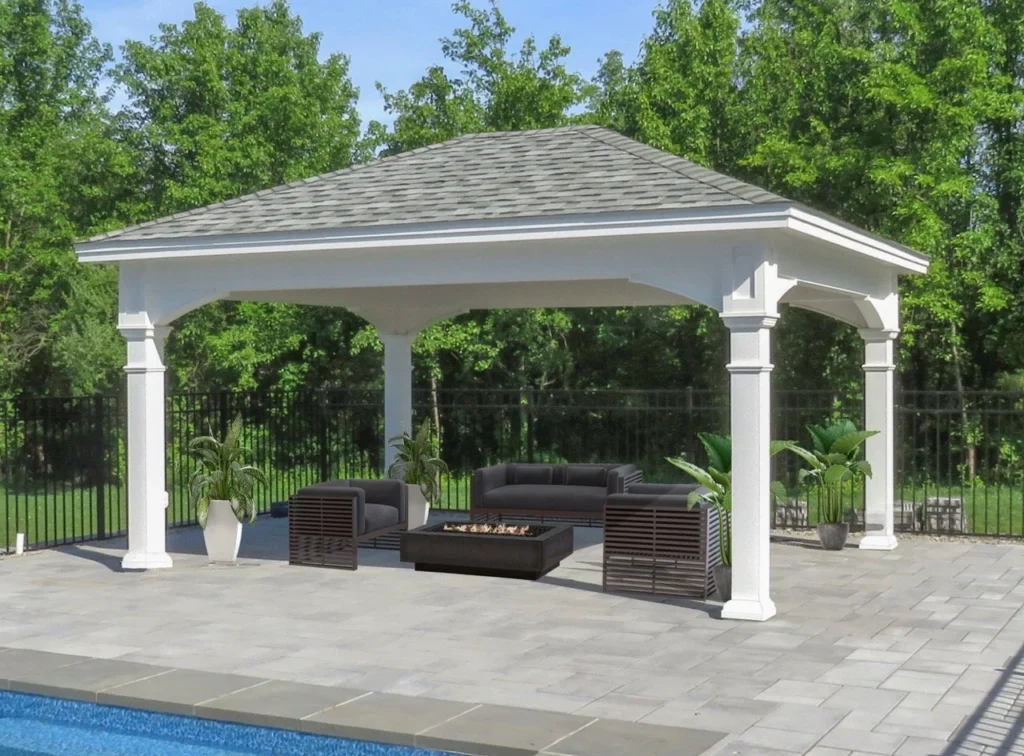 Manor Pavilion with white columns and a hip roof, shown with outdoor lounge furniture and a fire pit on a poolside patio.
